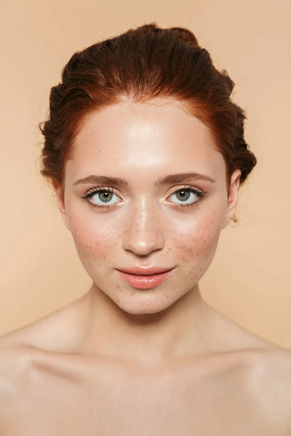 Close portrait of a person with clear, freckled skin